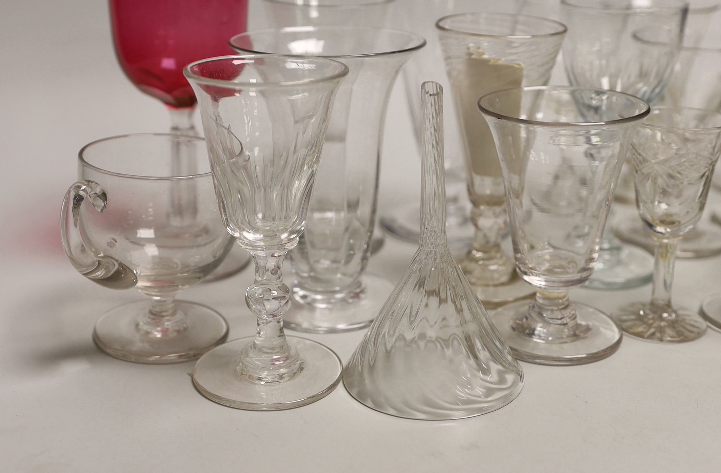 A quantity of antique and later glasses including a Georgian dwarf ale glass and Victorian cranberry example the largest 14cm high